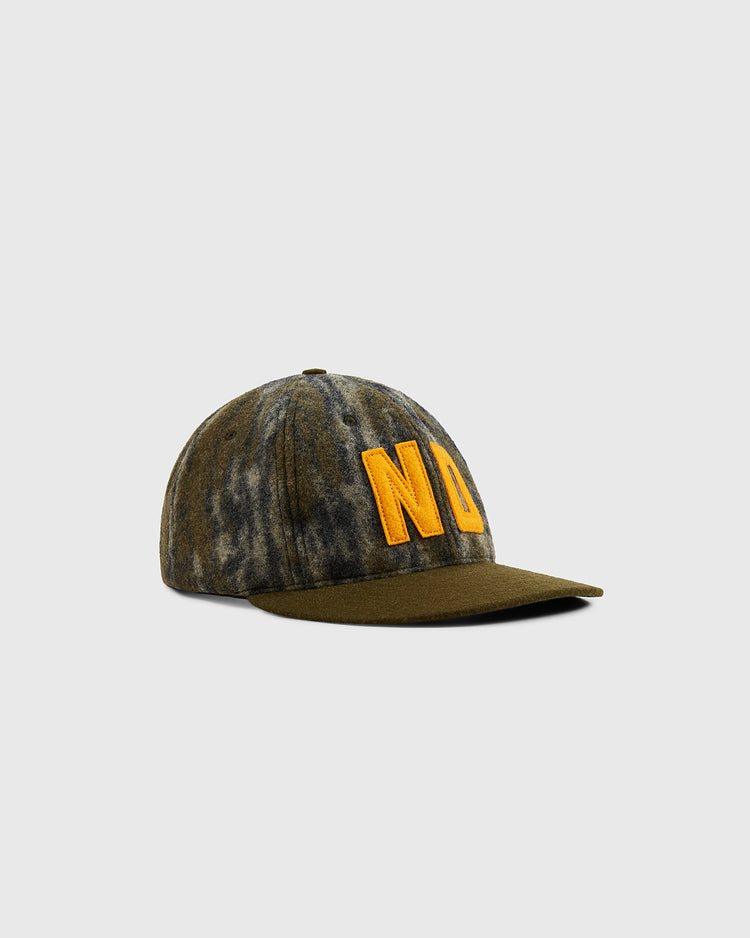 The Mossy Oak x Ebbets Field 1966 University of Notre Dame Ballcap by Ebbets Field features a green and gray tie-dye design with bold yellow NU lettering, shown against a plain light gray background.