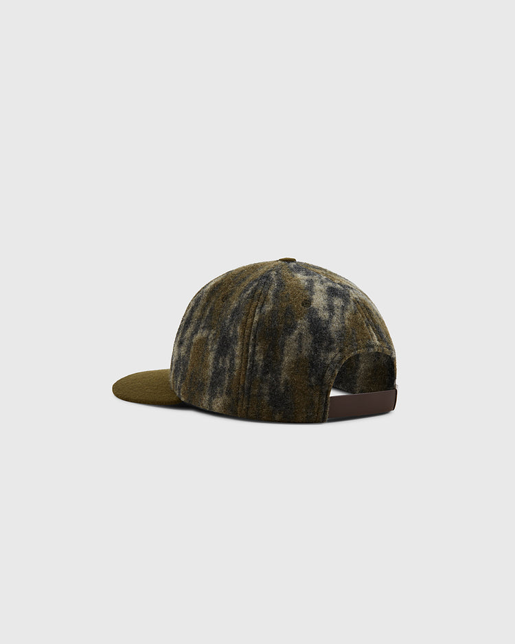 The Ebbets Field Mossy Oak x Sioux City Ghosts Ballcap, with a Mossy Oak Bottomland camo and olive green brim, is shown from the back and side with an adjustable brown strap on a light gray background.
