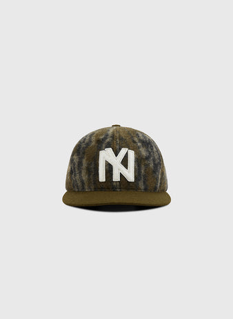 The Ebbets Field Mossy Oak x 1935 Brooklyn Eagles Ballcap features a Mossy Oak Bottomland camo design and a bold white NY logo on the front, shown on a plain gray background.