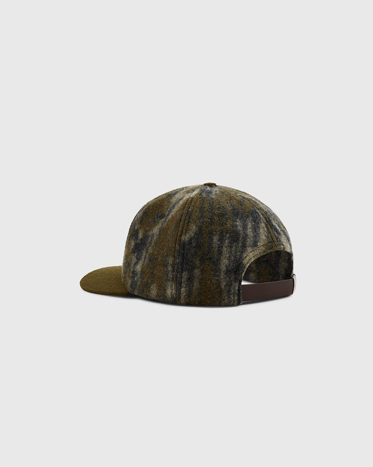 The Mossy Oak x Ebbets Field 1935 Brooklyn Eagles Ballcap by Ebbets Field is shown from the back, displaying a green and black tie-dye pattern, brown adjustable strap, and curved brim against a plain light gray background.