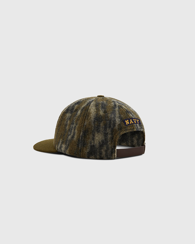 The Ebbets Field Mossy Oak x 1947 Navy Ballcap features a Mossy Oak Bottomland Camo wool design, 
