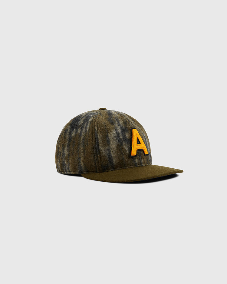 The Ebbets Field Mossy Oak x Ebbets Field 1957 Army Ballcap features a green and gray camo pattern, a bold yellow 