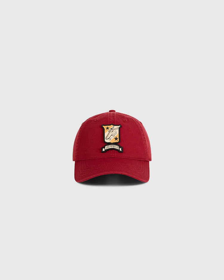 A red Ebbets Field Los Angeles Lincoln Park Roller Skating Rink Washed Cotton Ballcap features a colorful embroidered patch with a shield, stars, and 