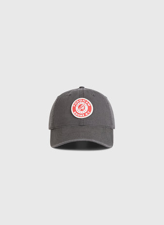 The Ebbets Field Fordham Bronx Roller Rink Washed Cotton Ballcap, dark gray with a circular red and white GOODRYN BOOKS INC. patch on the front, is shown against a plain light gray background.