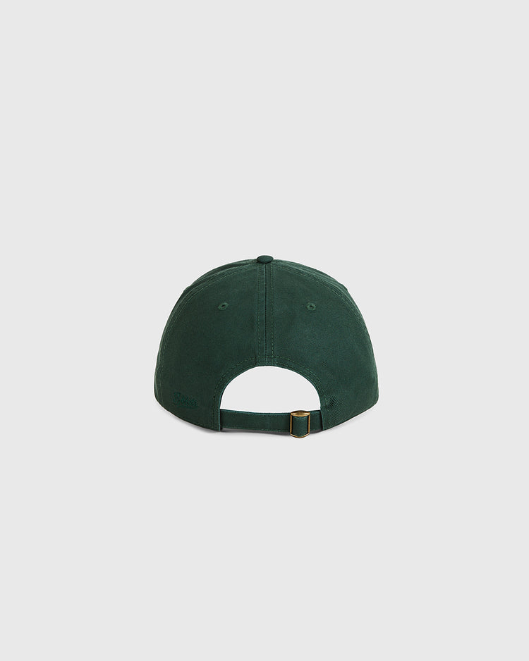 The Ebbets Field Queens Roller Rink Washed Cotton Ballcap in dark green is shown from the back on a light gray background, highlighting its adjustable fabric strap with metal buckle.