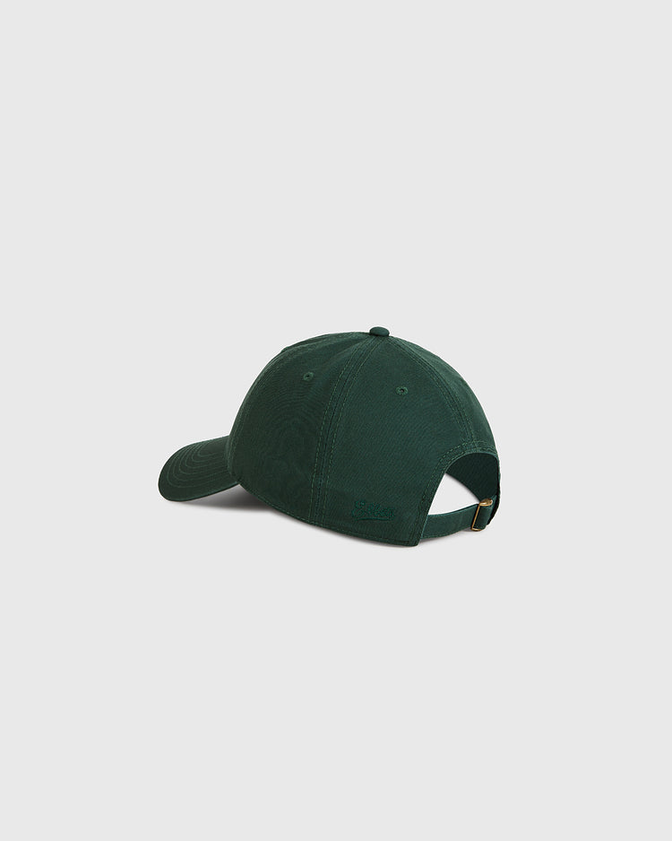 The Ebbets Field Queens Roller Rink Washed Cotton Ballcap is shown from the back, displaying its dark green color, adjustable strap with metal clasp, and small embroidered logo above the strap against a plain light gray background.