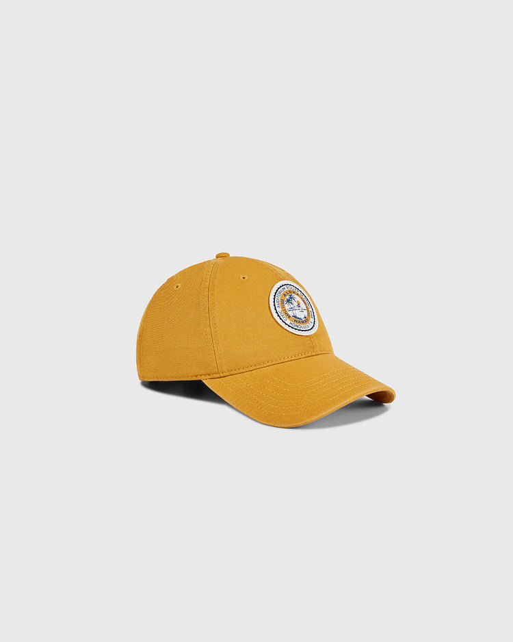The Ebbets Field Hawaii Civic Auditorium Roller Rink Washed Cotton Ballcap in mustard yellow features a curved brim and a round embroidered patch on the front, shown against a plain light gray background.