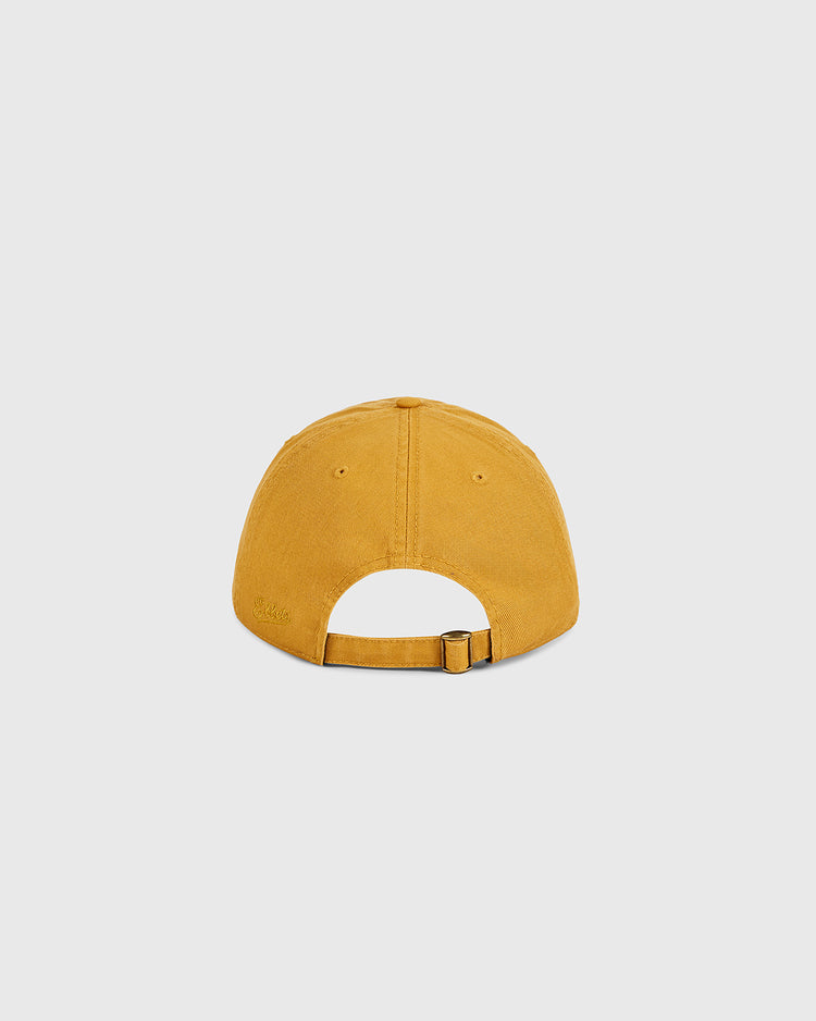 The Ebbets Field Hawaii Civic Auditorium Roller Rink Washed Cotton Ballcap, in mustard yellow, is shown from the back with an adjustable metal-buckle strap on a light gray background—a vintage-style hat inspired by the historic roller rink.