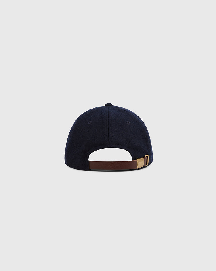 Ebbets Field Toronto City Series Wool Ballcap in navy blue broadcloth, rear view, highlights a brown leather adjustable strap with gold-tone buckle on a light grey background. Part of the City Series hat collection.