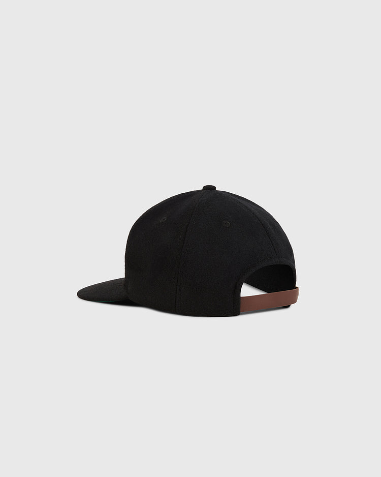 The Ebbets Field Chicago City Series Wool Ballcap is shown from the back with a curved brim and adjustable brown strap. Made of genuine wool broadcloth, this black hat is displayed against a plain light gray background.