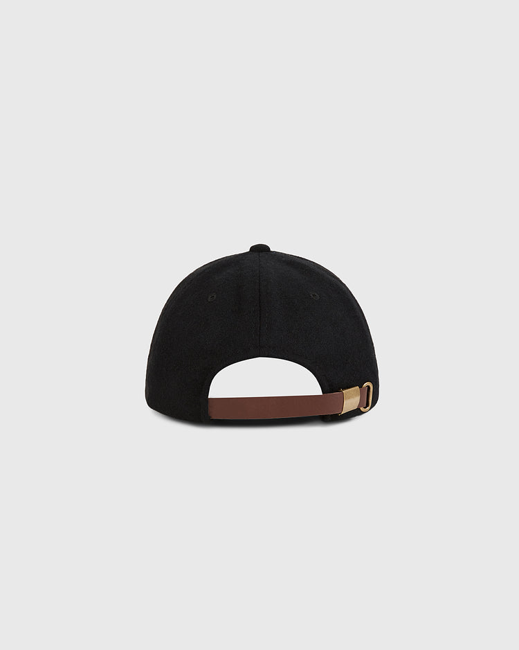 The Ebbets Field London City Series Wool Ballcap is shown from the back, displaying a brown adjustable strap with a gold buckle on a plain light gray background, crafted from genuine wool broadcloth for a premium feel.