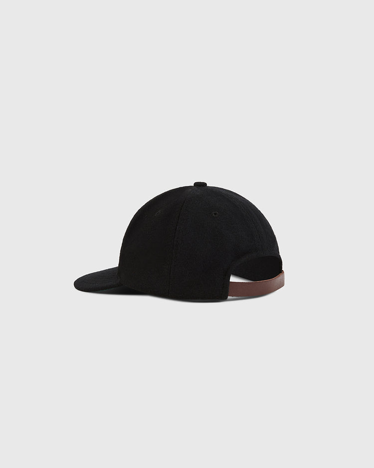 The Ebbets Field London City Series Wool Ballcap in black is shown from the back, with an adjustable brown strap closure in genuine wool broadcloth, set against a plain light gray background.