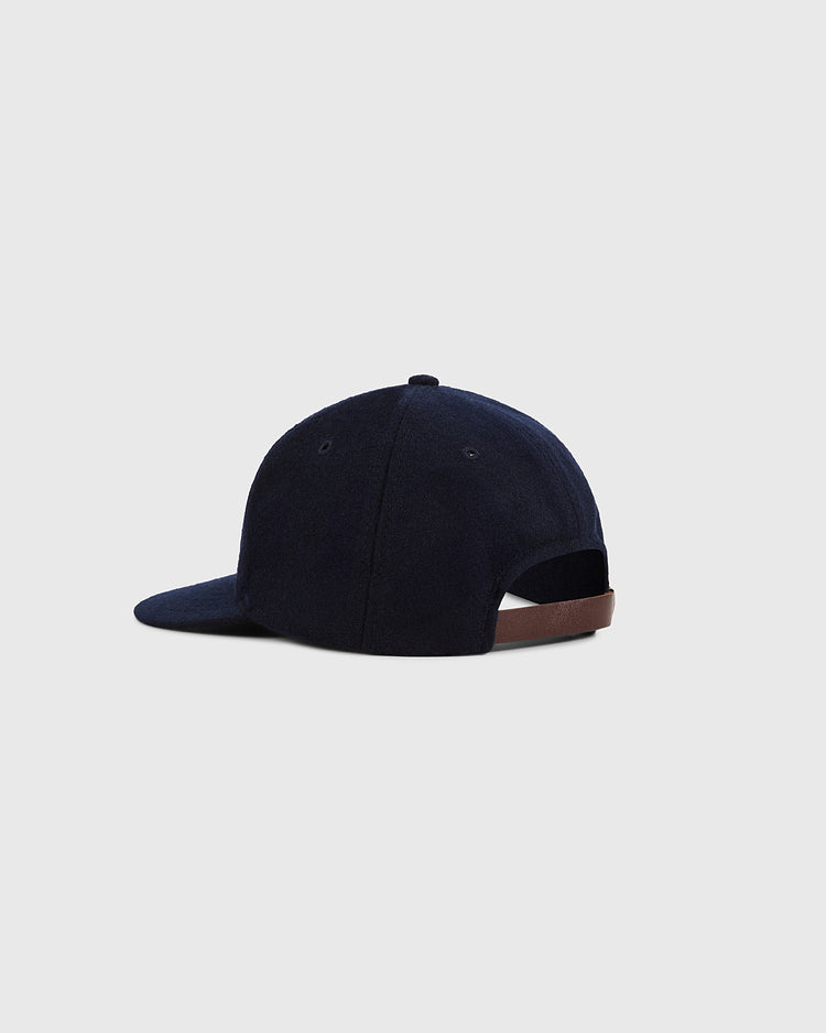 The Ebbets Field New York City Series Wool Ballcap in navy blue is shown from the back, displaying its brown adjustable strap and curved brim against a plain light gray background.