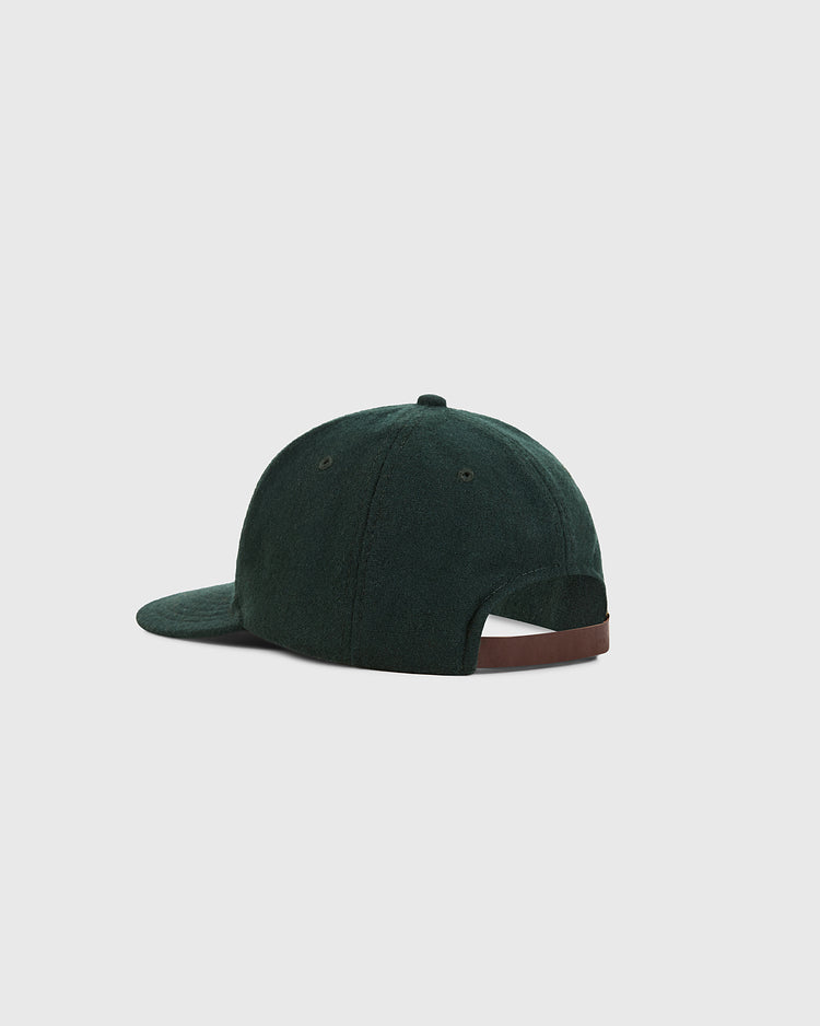 The Ebbets Field Mexico City City Series Wool Ballcap, in dark green, is shown from the back with a curved brim and an adjustable brown strap with metal buckle, set against a plain light gray background.