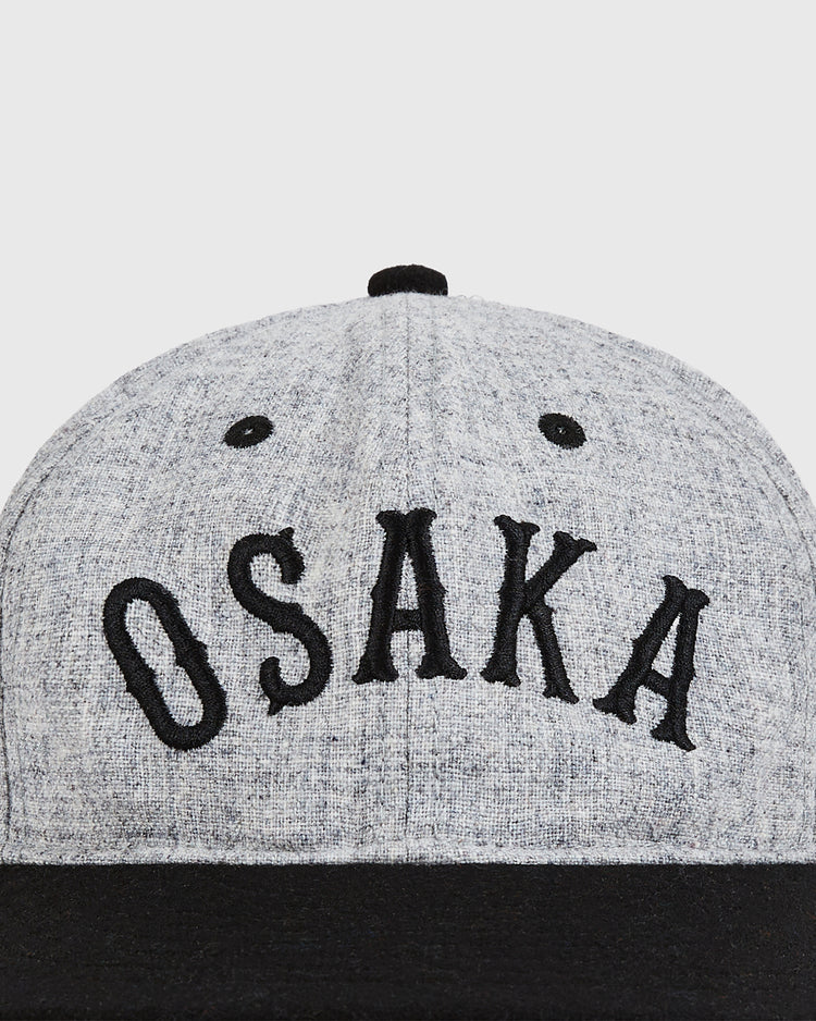 The Ebbets Field Osaka City Series Wool Ballcap is a gray cap with black trim and bold “OSAKA” embroidery on the front—a stylish pick for baseball cap fans.