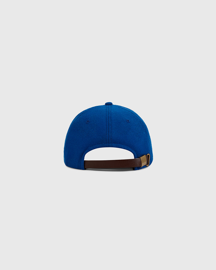 The Ebbets Field Puerto Rico 1972 National Team Wool Ballcap is shown from the back in blue wool, with a brown adjustable strap and metal buckle, set against a plain light gray background.