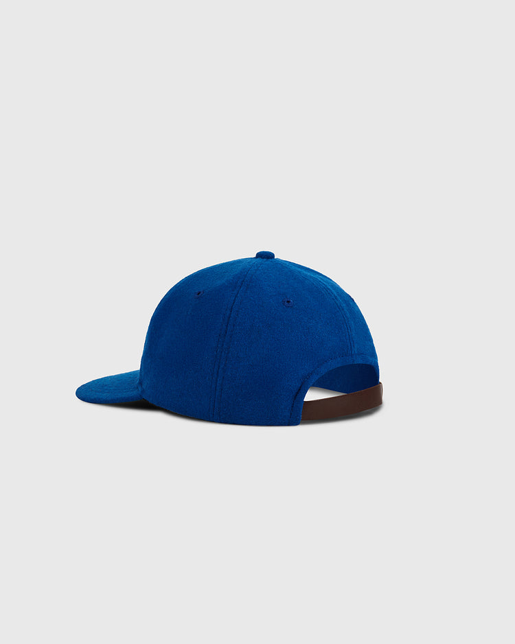 The Ebbets Field Puerto Rico 1972 National Team Wool Ballcap is shown from the back, featuring royal blue wool, a curved brim, and an adjustable brown strap against a light gray background.