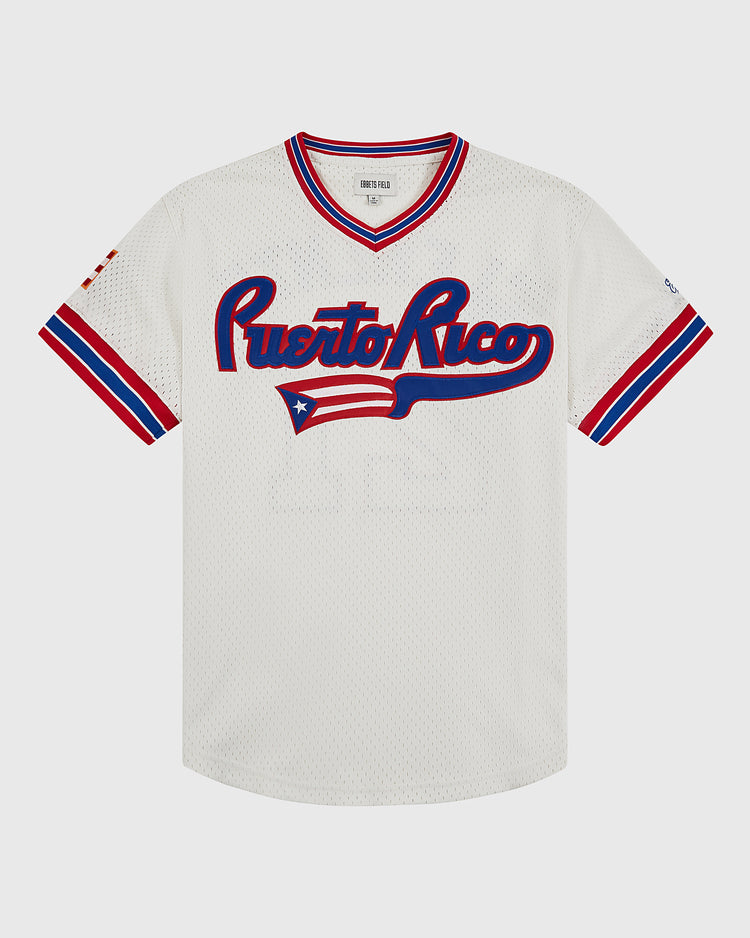 The Ebbets Field Puerto Rico 1972 National Team Mesh V-Neck Jersey features white mesh, red, blue, and white striped trim, “Puerto Rico” script on the front, and the Puerto Rican flag—an authentic tribute to the original national team jersey.