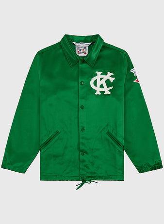 The EFF Kansas City Athletics 1963 Satin Windbreaker Jacket features a green design with a white KC logo on the chest, red and white sleeve patch, collar, side pockets, and drawstring hem for vintage MLB style.