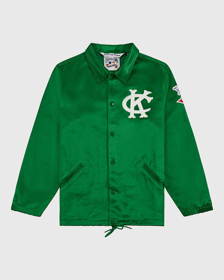 The EFF Kansas City Athletics 1963 Satin Windbreaker Jacket features a green design with a white KC logo on the chest, red and white sleeve patch, collar, side pockets, and drawstring hem for vintage MLB style.