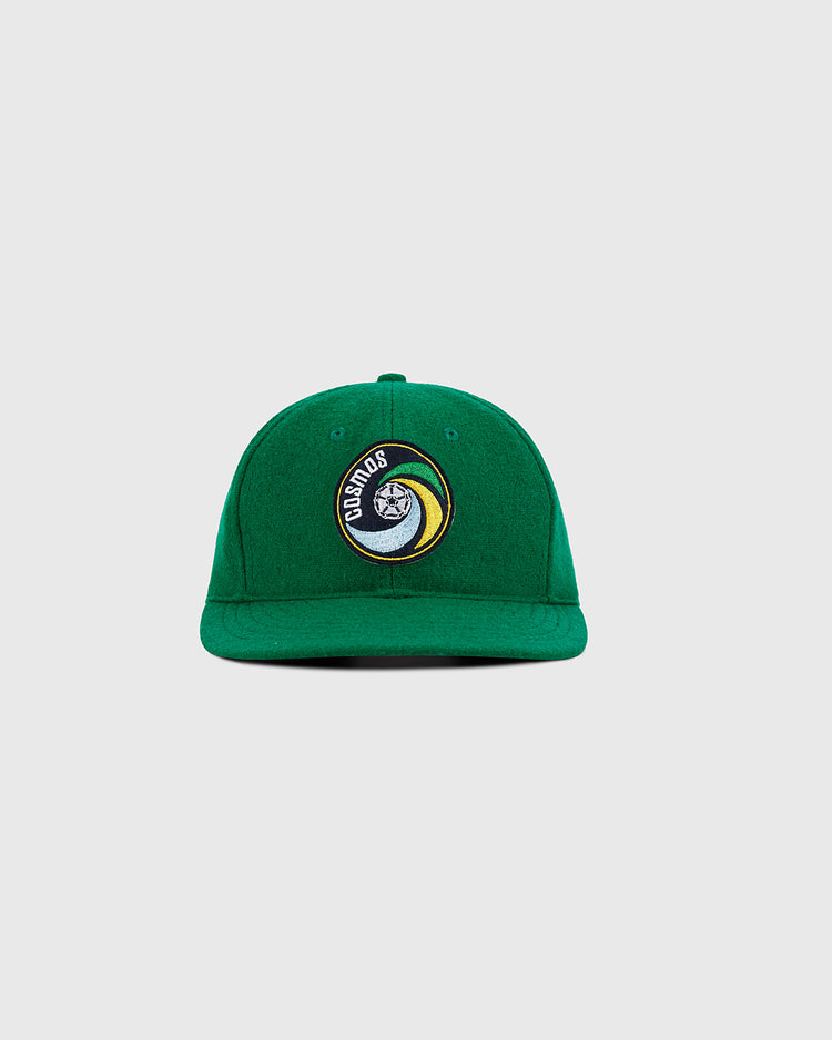 The Ebbets Field New York Cosmos Wool Ballcap features green wool, a front circular patch with a yin-yang face and 