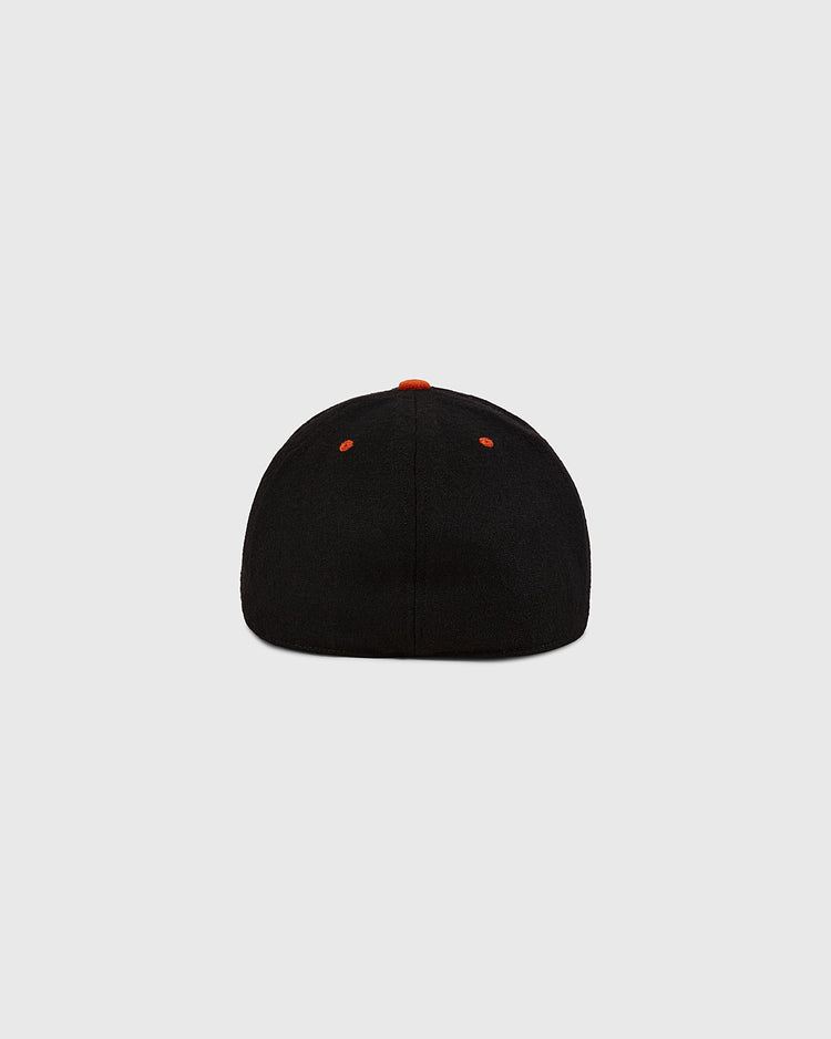 The Los Angeles Aztecs Wool Ballcap by Ebbets Field is shown from the back, featuring orange ventilation eyelets and a small orange top button, set against a plain light gray background.