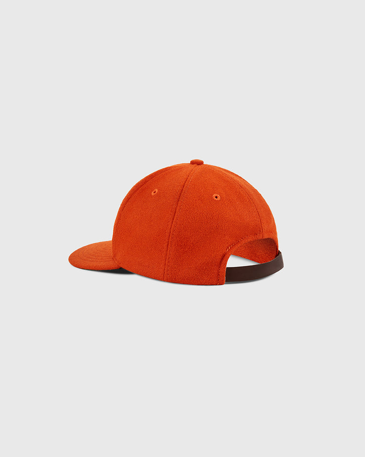 The Ebbets Field Los Angeles Aztecs Vintage Wool Ballcap, shown from the back and side on a light gray background, features bright orange wool, a curved brim, and a dark adjustable back strap inspired by the North American Soccer League.