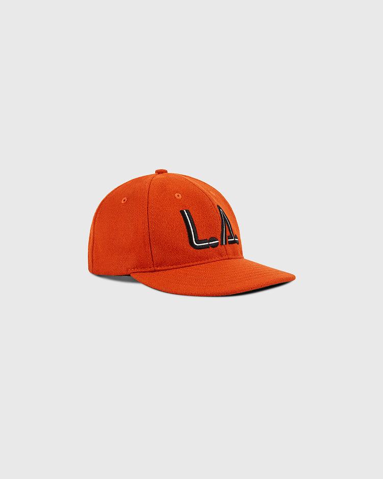The Ebbets Field Los Angeles Aztecs Vintage Wool Ballcap, featuring bold black LA letters on orange wool, is shown against a plain light gray background.