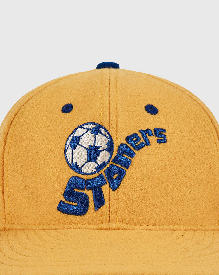 The Ebbets Field Pennsylvania Stoners Wool Ballcap is yellow with blue embroidery, featuring a soccer ball and 
