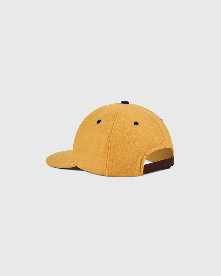 The Ebbets Field Pennsylvania Stoners Wool Ballcap is shown from the back, highlighting its yellow color, curved brim, blue accent eyelets, adjustable strap, and a plain white background.