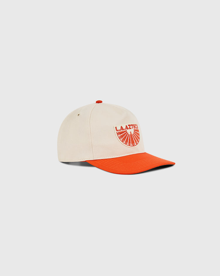 The Ebbets Field Los Angeles Aztecs A-Frame Cotton Twill Ballcap features a beige structured snapback with an orange brim and button, plus an embroidered orange and white Aztecs logo above a sunburst on the front.