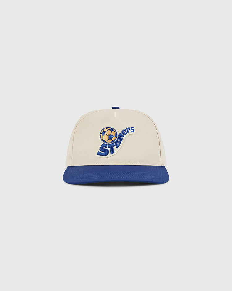 The Ebbets Field Pennsylvania Stoners A-Frame Cotton Twill Ballcap features a beige crown, blue brim, and a soccer ball logo above 