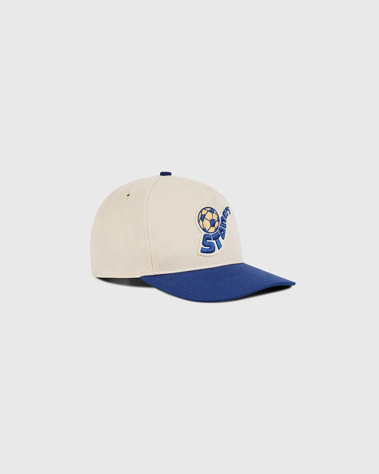 The Ebbets Field Pennsylvania Stoners A-Frame Cotton Twill Ballcap features a beige crown, blue brim, and an embroidered soccer ball logo above 