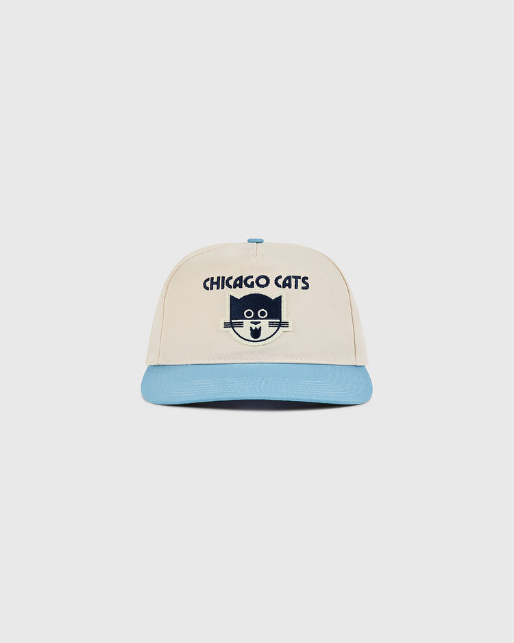 The Ebbets Field Chicago Cats A-Frame Cotton Twill Ballcap sports a beige and light blue retro look with a cartoon cat face and CHICAGO CATS text—perfect for American Soccer League fans and collectors.