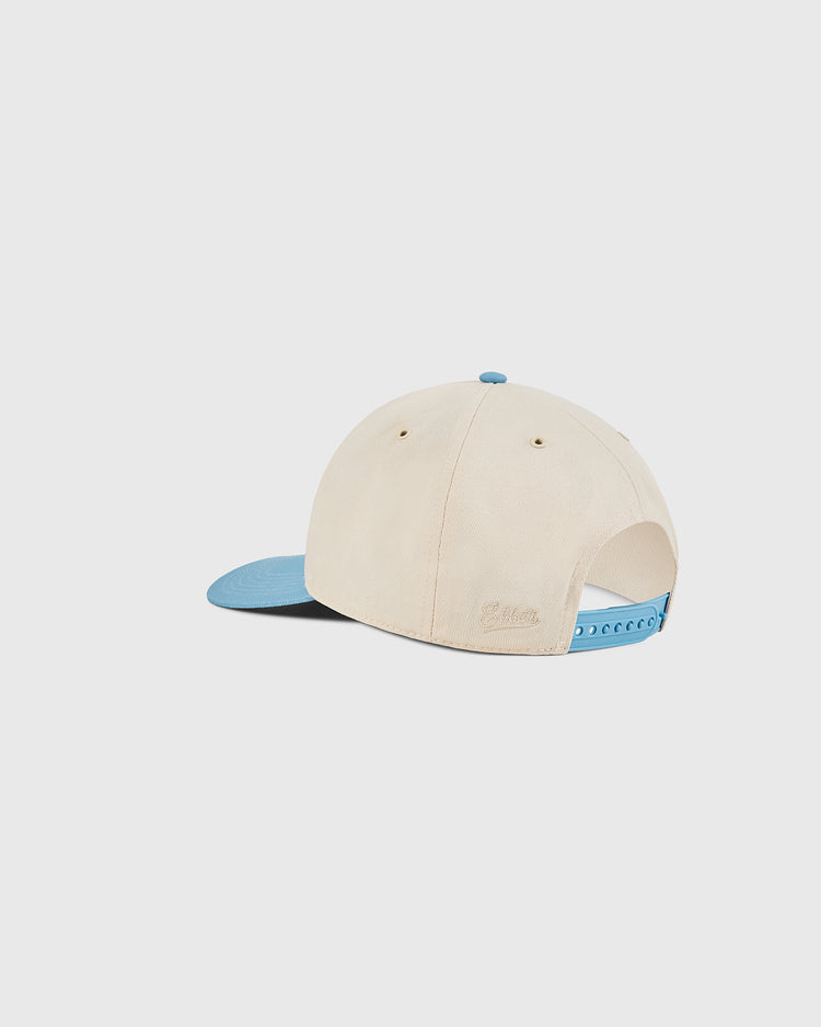 The Ebbets Field Chicago Cats A-Frame Cotton Twill Ballcap features a beige retro look with a light blue brim and adjustable blue strap—ideal for fans of vintage American Soccer League styles.