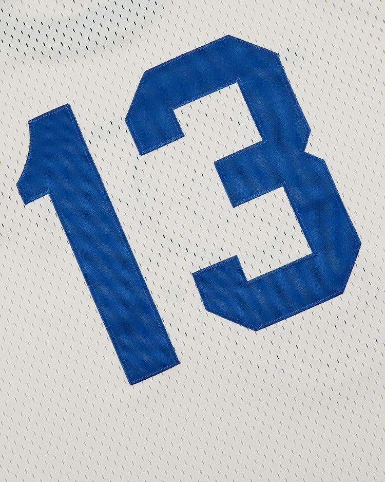 The Ebbets Field Pennsylvania Stoners Mesh Soccer Jersey features white mesh fabric with small perforations and bold blue number 13 print, inspired by the iconic ASL champions.