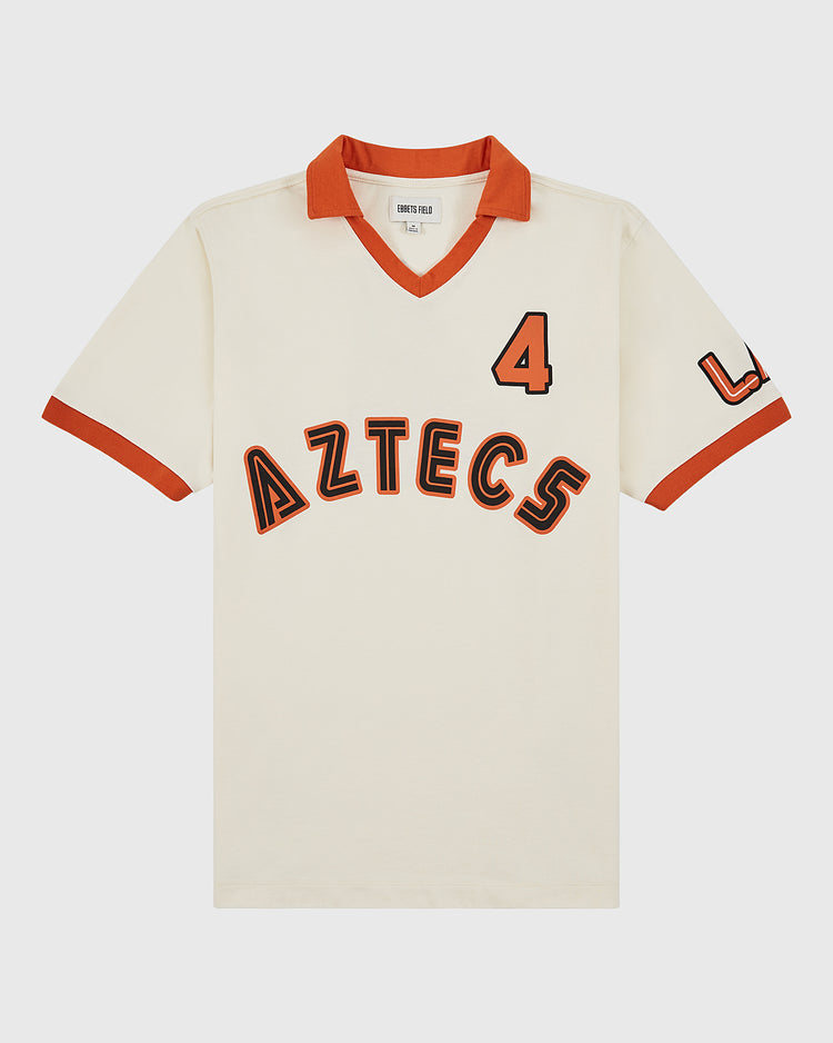 The Los Angeles Aztecs Vintage Collar Soccer Jersey by Ebbets Field features a cream cotton design with red-trimmed collar and sleeves, bold red-and-black 
