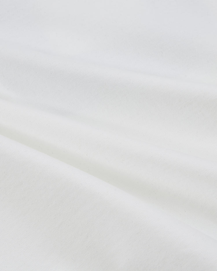 Close-up of the Ebbets Field New York Cosmos Vintage Collar Soccer Jersey, featuring soft white cotton with gentle folds and smooth texture that capture the timeless charm of a classic soccer icon.
