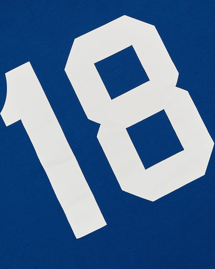 A bold white number 18 stands out on blue fabric of the Ebbets Field Pennsylvania Stoners Vintage Collar Soccer Jersey, recalling classic screen-printed athletic styles.