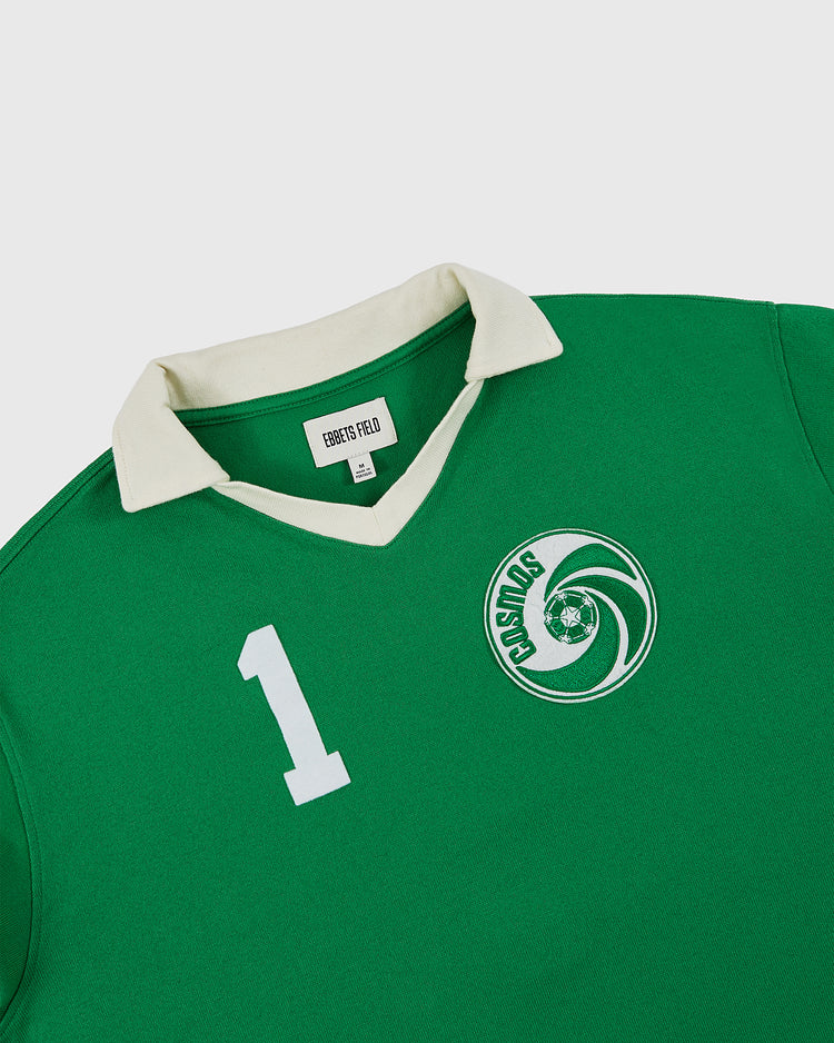 The Ebbets Field New York Cosmos Vintage Soccer Goalie Jersey features green fabric, a collared long sleeve design, a white number 1 on the chest, and the COSMOS circular swirling logo. The inner tag reads ROBERTS & PAULO.