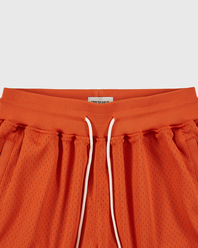 Close-up of the waistband of Ebbets Field Los Angeles Aztecs Mesh Soccer Shorts, featuring an elastic band, white drawstrings, and side pockets. Inspired by classic soccer apparel, shown against a light background.