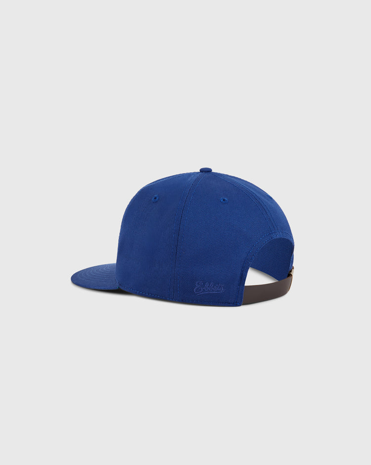 The Ebbets Field Kansas City Spurs Cotton Twill Ballcap in royal blue is shown from the back, with an adjustable brown strap and embroidered branding above the strap—all on a light gray background.