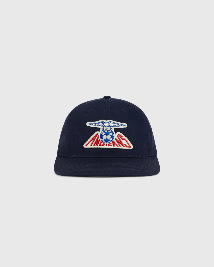 The Ebbets Field New Jersey Americans Cotton Twill Ballcap is navy blue with a front patch of a blue eagle holding a soccer ball over 