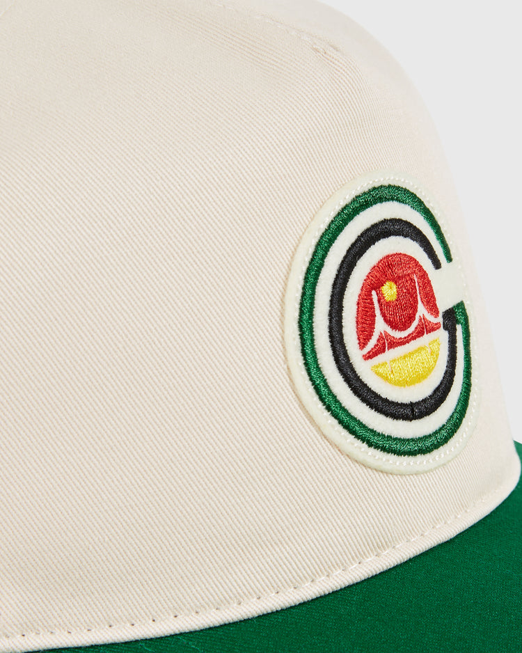 Close-up of the Ebbets Field San Francisco Golden Gate Gales A-Frame Cotton Twill Ballcap in beige and green, featuring a stitched logo with a green outlined 