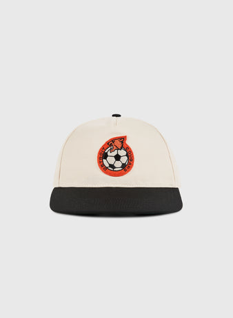 The Ebbets Field Detroit Cougars A-Frame Cotton Twill Ballcap, in beige with a black brim and an embroidered red and black soccer ball and horse's head emblem, is shown against a plain white background.