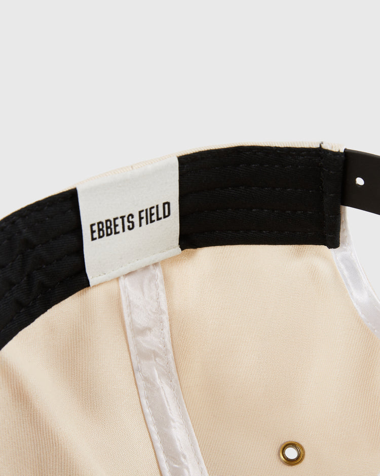 Close-up of the Detroit Cougars A-Frame Cotton Twill Ballcap by Ebbets Field, highlighting the white EBBETS FIELD label on the black inner band, plus visible stitching, metal grommets, and classic cotton twill details.