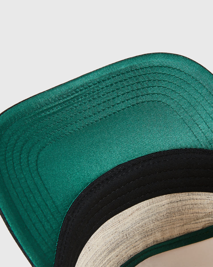 Close-up of the underside of an Ebbets Field Detroit Cougars A-Frame Cotton Twill Ballcap, highlighting green brim stitching and the black and beige cotton twill inner band.