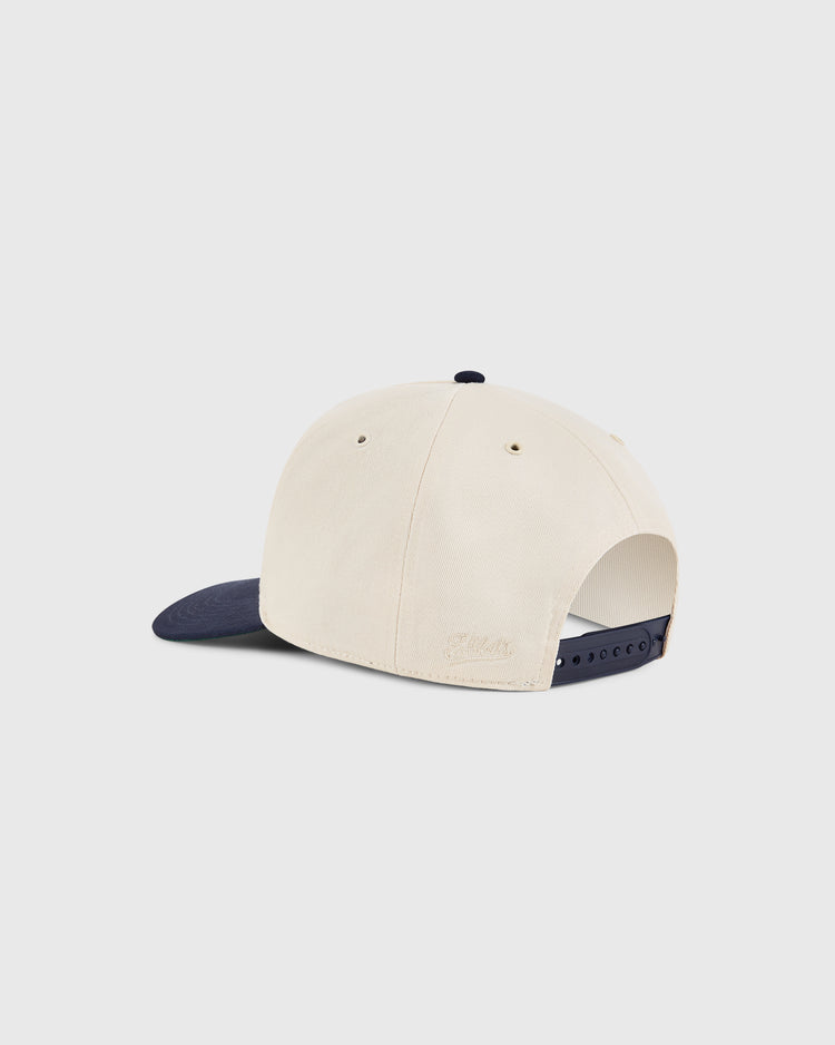 The New Jersey Americans A-Frame Cotton Twill Ballcap by Ebbets Field features a cream retro snapback design with a navy blue brim and adjustable closure, displayed from the back on a plain white background.