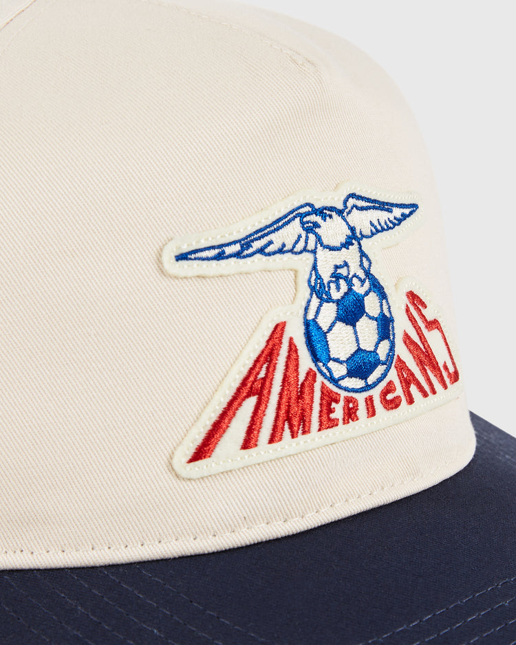 The Ebbets Field New Jersey Americans A-Frame Cotton Twill Ballcap features a beige and navy design with an eagle embroidered above red 