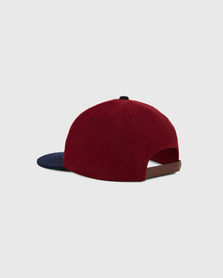 The Ebbets Field San Francisco Seals 1940 Wool Ballcap features a burgundy crown, navy blue brim, and brown adjustable strap, inspired by the Pacific Coast League. Shown on a plain light gray background.